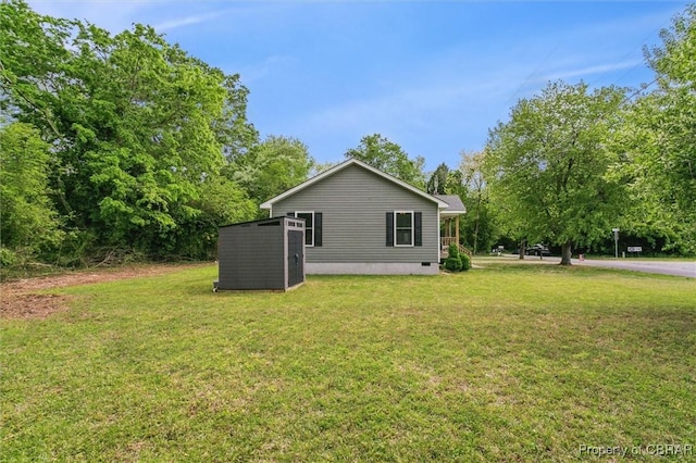 rear view of house with a yard and crawl space