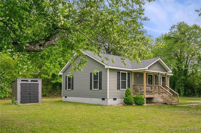 back of house featuring a lawn, a storage unit, covered porch, and crawl space