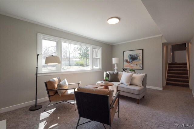living area featuring baseboards, ornamental molding, carpet flooring, and stairs