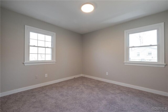 empty room featuring baseboards, carpet flooring, and a healthy amount of sunlight