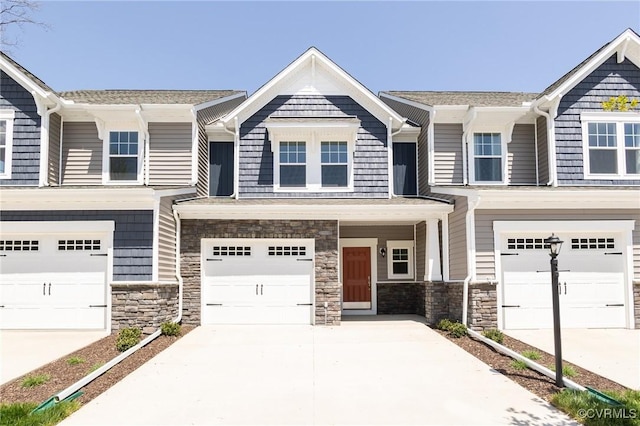 18731 Palisades Rdg, Moseley, VA 23120 - view of front facade with an attached garage, stone siding, and concrete driveway