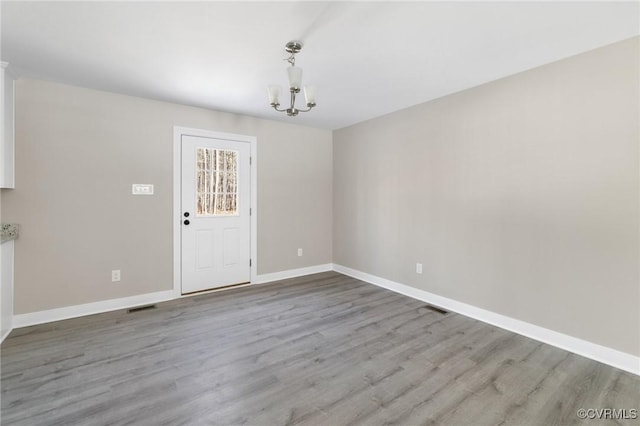 4206 Mattaponi Ave, West Point, VA 23181 - unfurnished dining area featuring a chandelier, wood finished floors, and baseboards