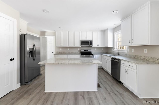 4206 Mattaponi Ave, West Point, VA 23181 - kitchen with stainless steel appliances, a sink, light wood-style flooring, white cabinets, and recessed lighting