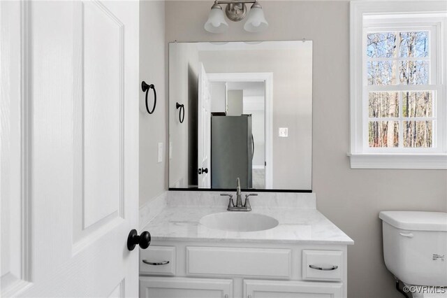 bathroom featuring toilet and vanity