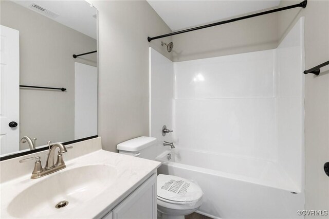 bathroom featuring toilet, visible vents, shower / washtub combination, and vanity