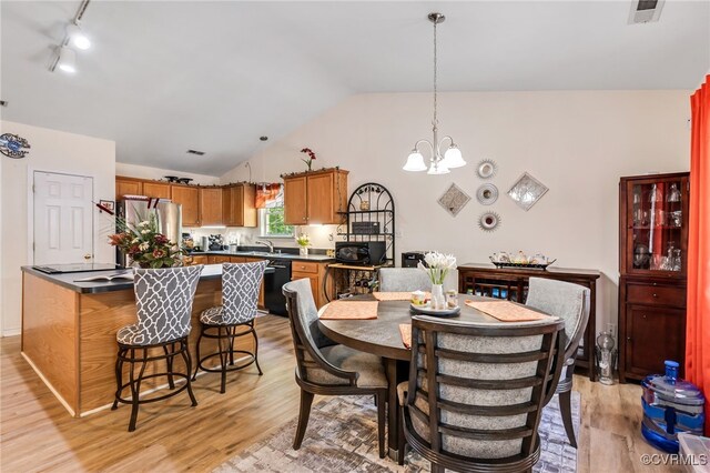 5841 Tuskwillow Dr, Richmond, VA 23832 - dining room featuring a notable chandelier, visible vents, light wood-style flooring, and lofted ceiling