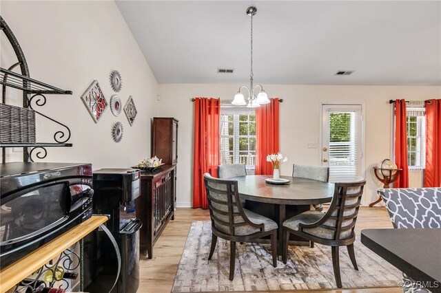 5841 Tuskwillow Dr, Richmond, VA 23832 - dining space with visible vents, light wood finished floors, and a notable chandelier