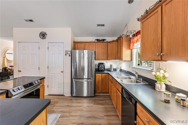5841 Tuskwillow Dr, Richmond, VA 23832 - kitchen with a sink, appliances with stainless steel finishes, dark countertops, and visible vents