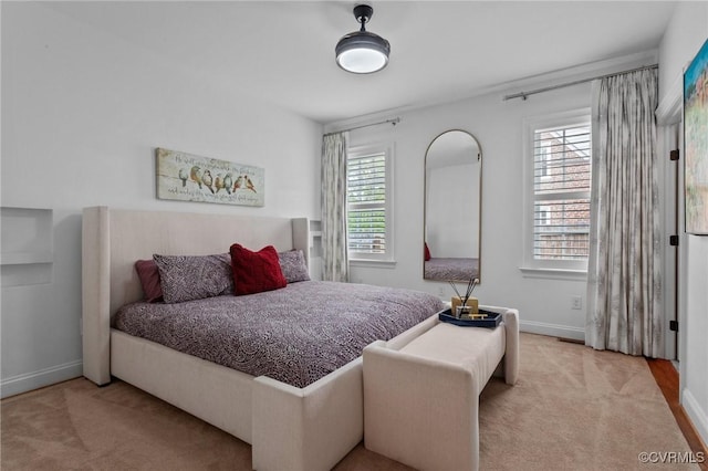 carpeted bedroom featuring baseboards