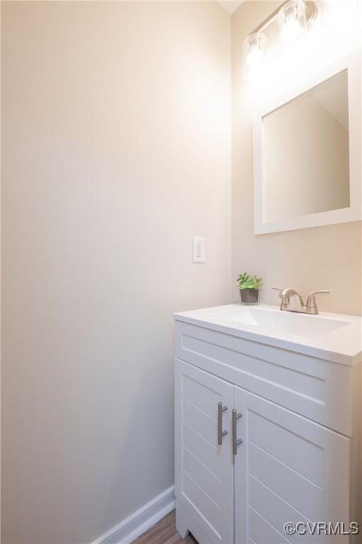 bathroom with vanity and baseboards