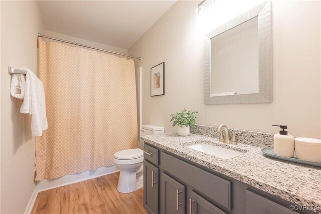 full bathroom featuring vanity, toilet, and wood finished floors