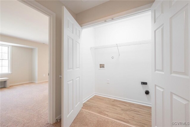 washroom featuring laundry area, baseboards, washer hookup, and light colored carpet