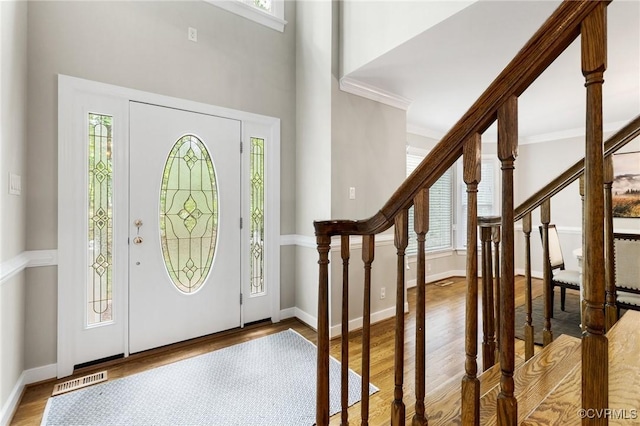 entryway with baseboards, wood finished floors, and a healthy amount of sunlight