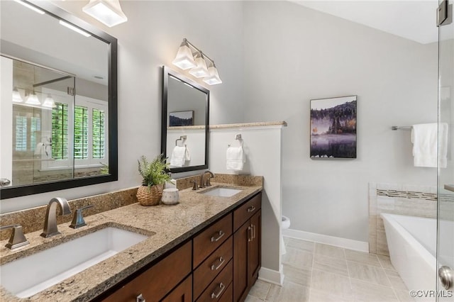 full bathroom featuring double vanity, a sink, baseboards, and a shower stall