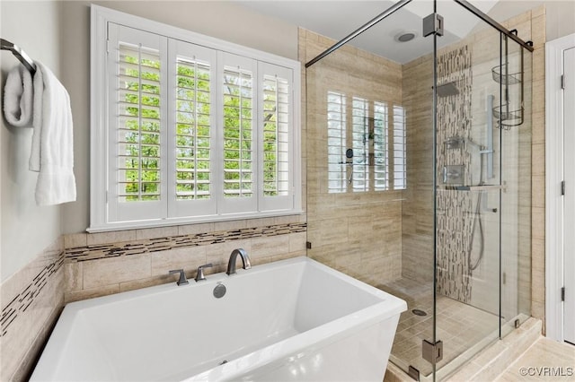 bathroom with a freestanding bath and a stall shower