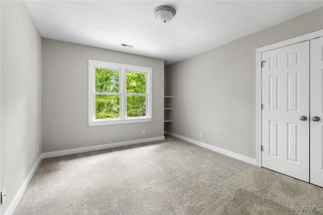 carpeted empty room with baseboards