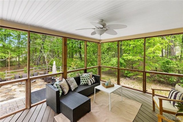 sunroom with ceiling fan and an outdoor hangout area