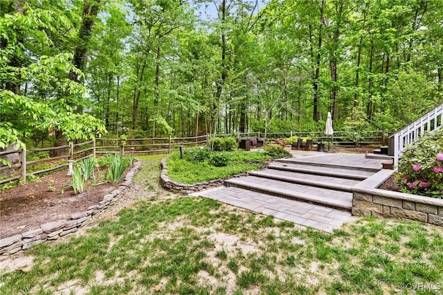 view of yard featuring fence and a wooded view
