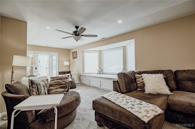 living area featuring ceiling fan, light carpet, recessed lighting, and visible vents