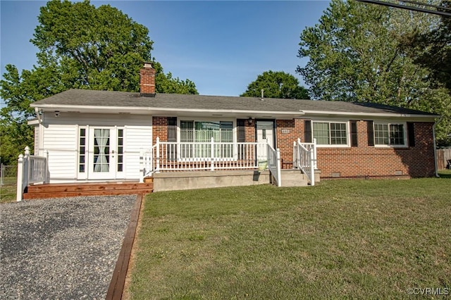 ranch-style home featuring a front lawn, roof with shingles, a chimney, brick siding, and crawl space