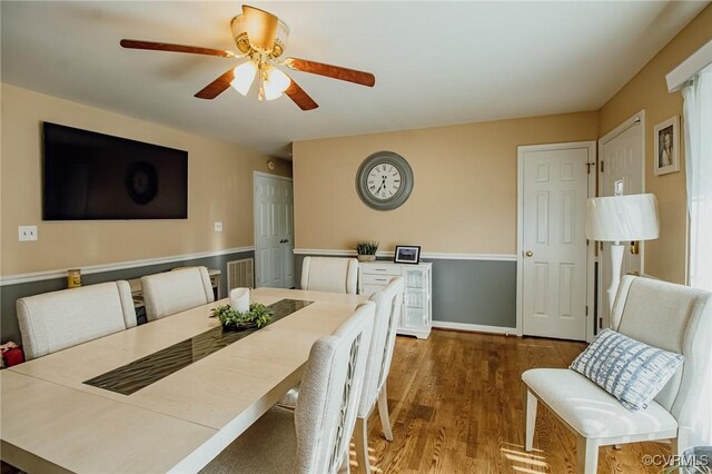 dining area with a ceiling fan and wood finished floors