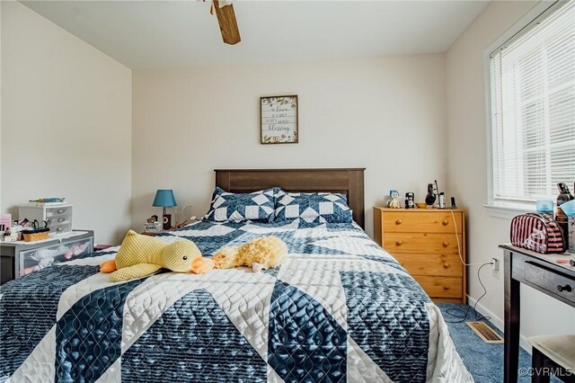 bedroom featuring baseboards and ceiling fan