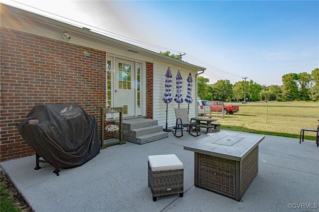 view of patio featuring grilling area and fence