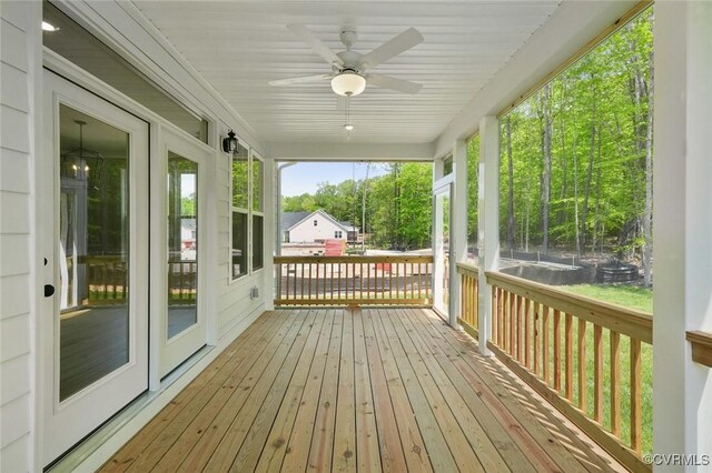 wooden terrace featuring a ceiling fan