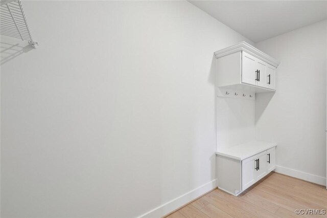 mudroom with baseboards and light wood-type flooring