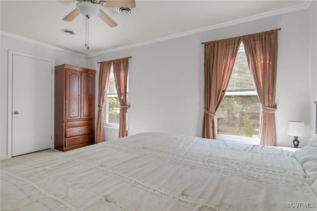 bedroom featuring visible vents, multiple windows, and ornamental molding