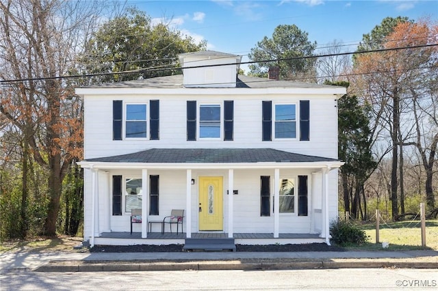 american foursquare style home featuring covered porch