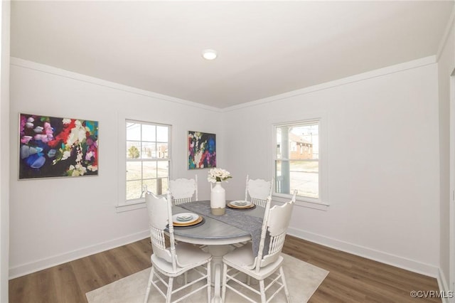 dining room featuring baseboards and wood finished floors