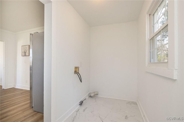 clothes washing area featuring laundry area, hookup for a washing machine, baseboards, and marble finish floor