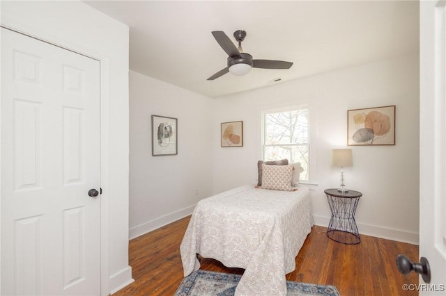 bedroom with baseboards, ceiling fan, and wood finished floors