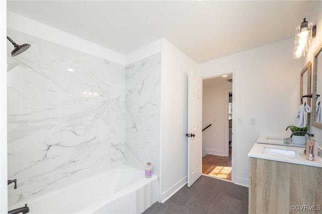 full bathroom featuring double vanity, shower / bathtub combination, and baseboards