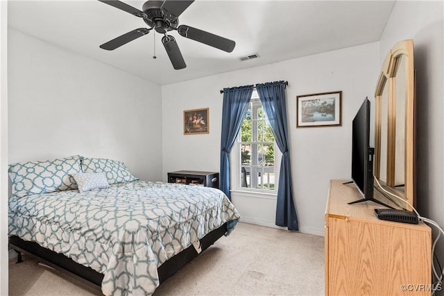 bedroom featuring visible vents, baseboards, ceiling fan, and light colored carpet