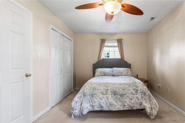 bedroom featuring visible vents, baseboards, a closet, and light carpet