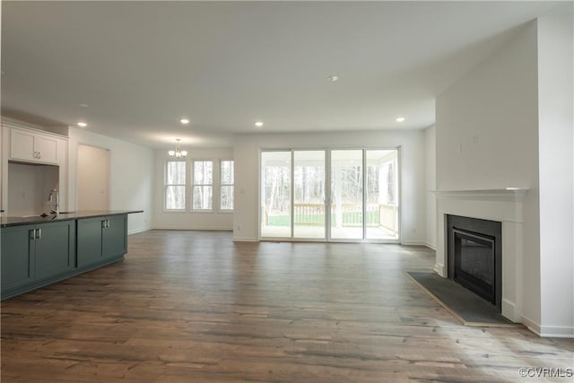 6081 Brickshire Dr, Providence Forge, VA 23140 - unfurnished living room featuring a glass covered fireplace, recessed lighting, wood finished floors, and a chandelier