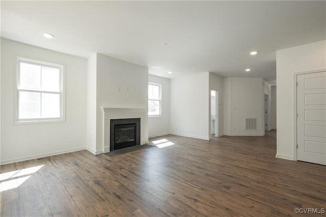 6081 Brickshire Dr, Providence Forge, VA 23140 - unfurnished living room featuring recessed lighting, baseboards, a fireplace with flush hearth, visible vents, and dark wood-style floors