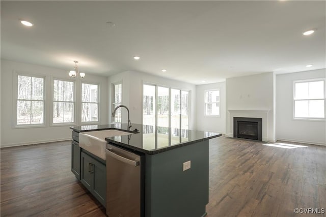 6081 Brickshire Dr, Providence Forge, VA 23140 - kitchen featuring stainless steel dishwasher, a center island with sink, dark wood-type flooring, a sink, and a notable chandelier