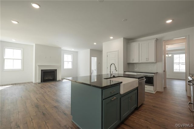 6081 Brickshire Dr, Providence Forge, VA 23140 - kitchen featuring a sink, dishwasher, a fireplace, dark wood-type flooring, and a center island with sink