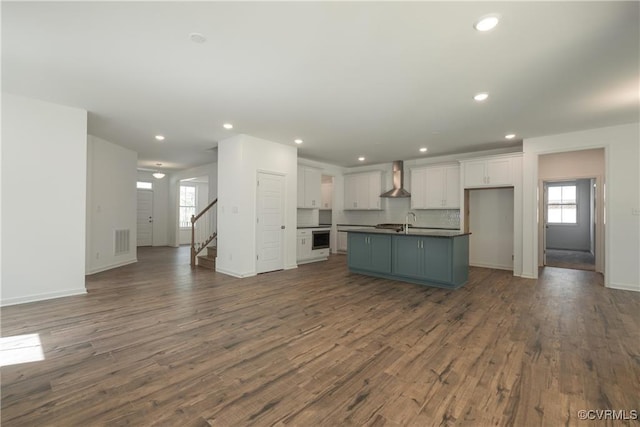 6081 Brickshire Dr, Providence Forge, VA 23140 - kitchen with white cabinetry, open floor plan, plenty of natural light, and wall chimney exhaust hood