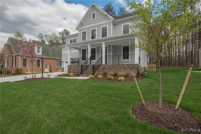 6081 Brickshire Dr, Providence Forge, VA 23140 - view of front of house with brick siding, board and batten siding, covered porch, and a front yard