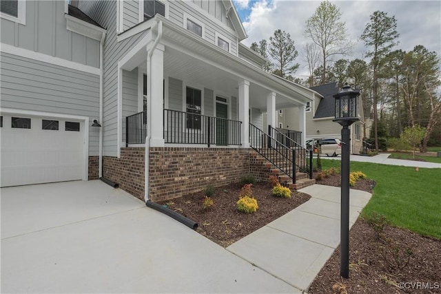 6081 Brickshire Dr, Providence Forge, VA 23140 - view of side of property featuring brick siding, a garage, board and batten siding, a porch, and driveway