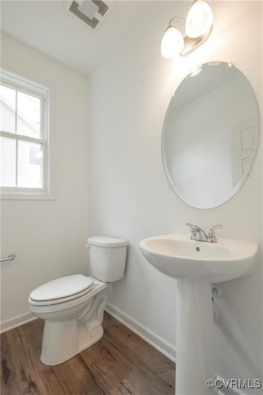 6081 Brickshire Dr, Providence Forge, VA 23140 - half bath with toilet, baseboards, visible vents, and wood finished floors