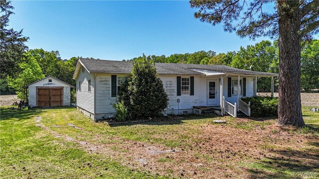view of front of home with an outdoor structure, crawl space, a shed, and a front yard