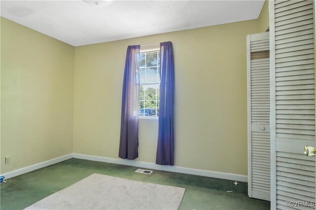 interior space featuring baseboards, concrete flooring, and visible vents