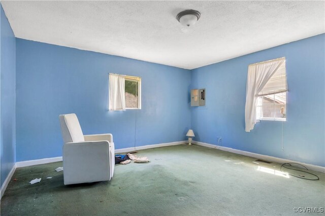 unfurnished room featuring baseboards, carpet flooring, and a textured ceiling