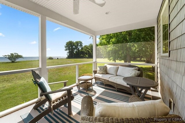 sunroom / solarium with an outdoor hangout area, ceiling fan, and a water view