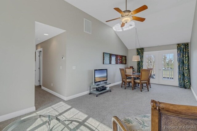 living room with ceiling fan, carpet floors, baseboards, lofted ceiling, and visible vents